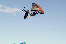 Load image into Gallery viewer, Person on a wingsuit flying through the sky with a colorful wing ozone Flow v2 branding on a white background wingfoil portugal
